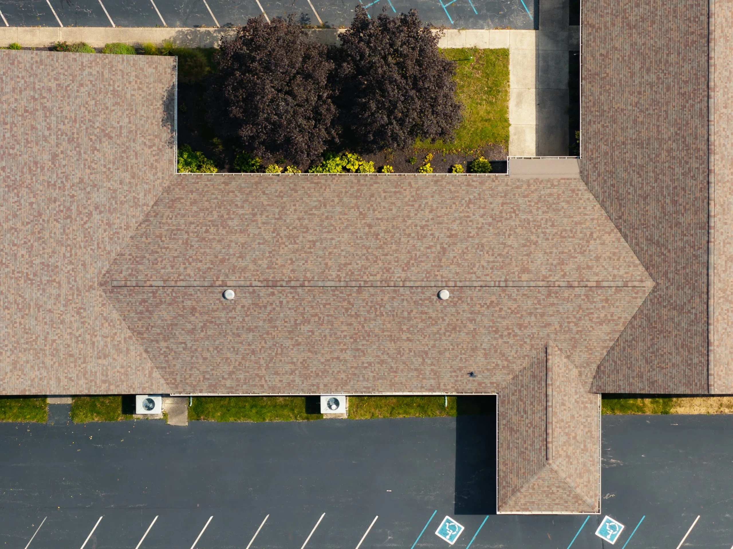 Top-down view of a commercial church roof plan with multiple roof sections and drainage paths