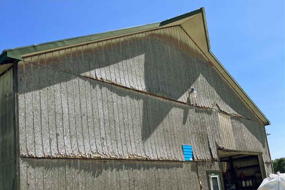 Weathered commercial metal exterior documented before repair and restoration work