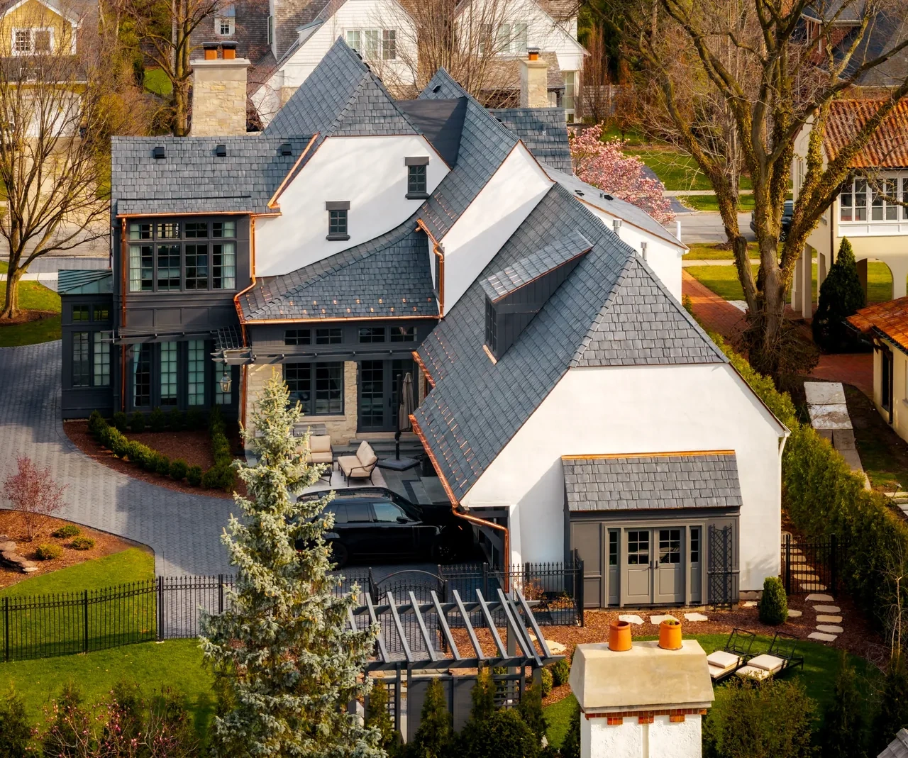 Aerial view of a completed Brava synthetic slate roof with custom copper gutters and flashing by Locke & Ladder