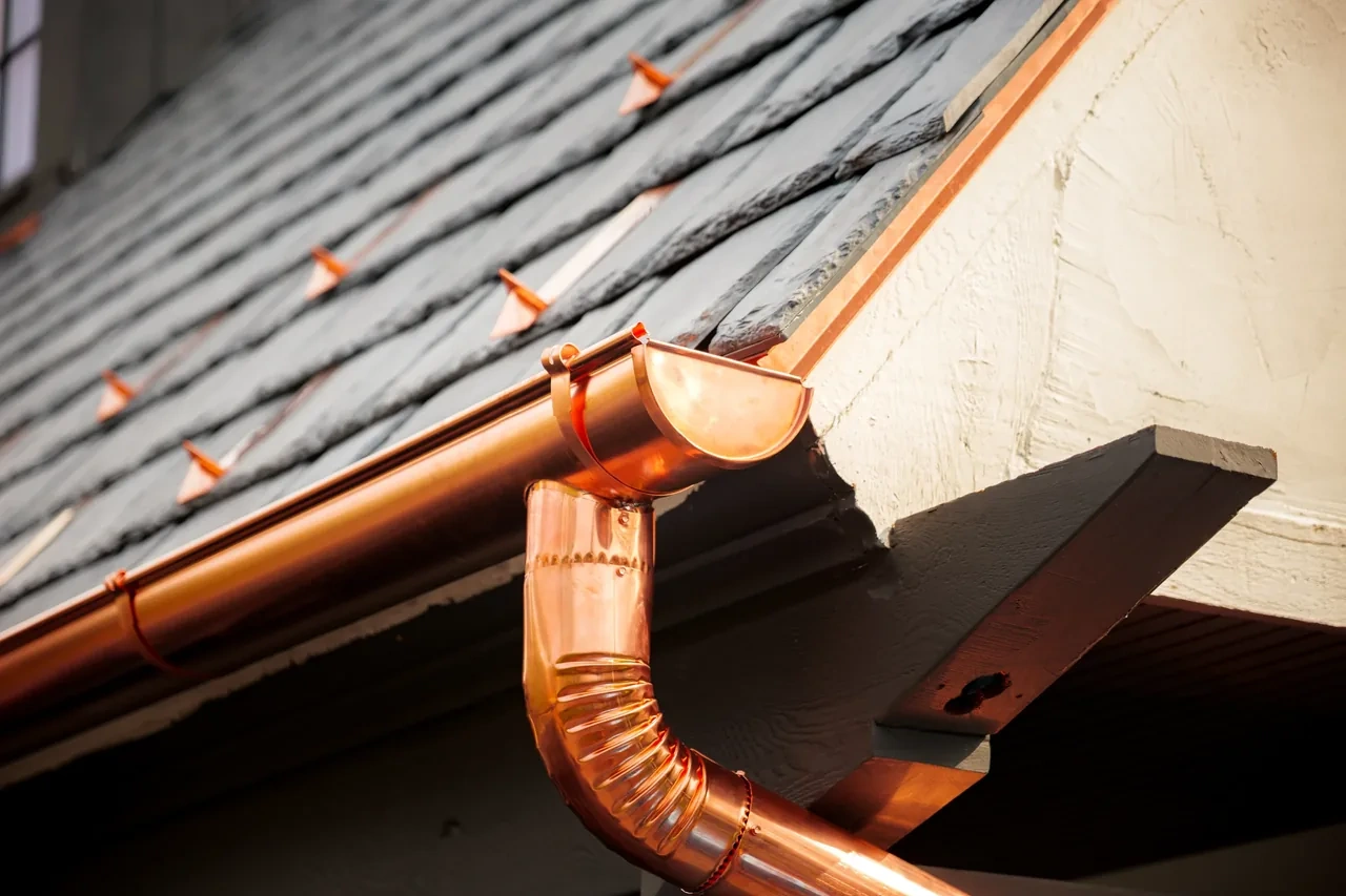 Copper half-round gutter and downspout at the Hinsdale residence by Locke & Ladder