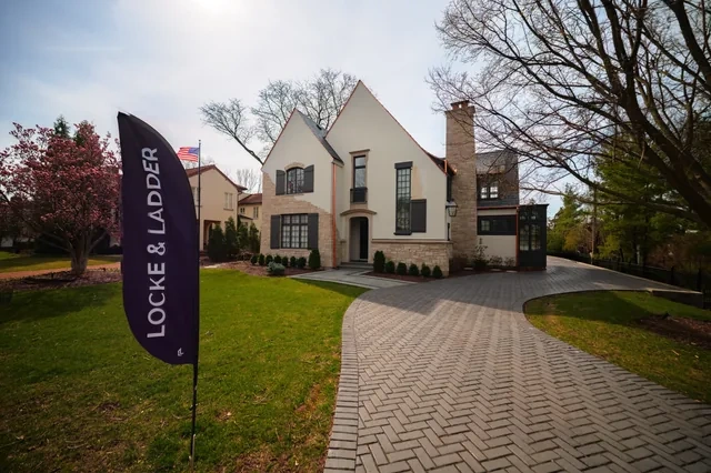Front exterior wide view with curved driveway after the Hinsdale Brava roof project