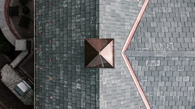 Overhead view of a Brava synthetic slate roof with copper hip flashing, a copper-clad cap, and copper snow guards in Meridian Hills, Indianapolis