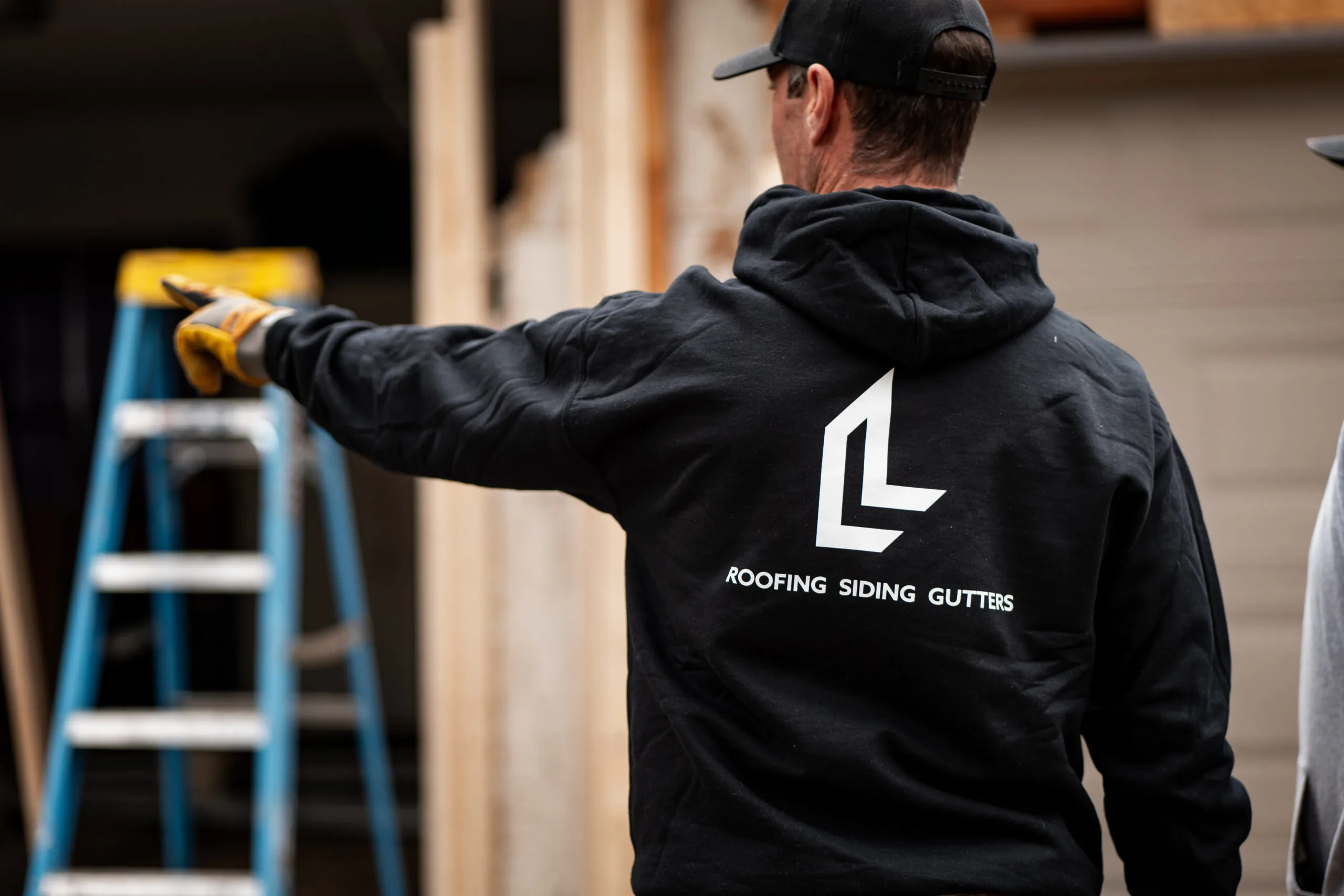 Locke & Ladder team member documenting exterior conditions during a project inspection