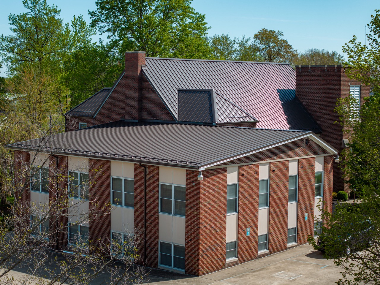 Close view of commercial standing-seam metal roof panels, seams, and transitions