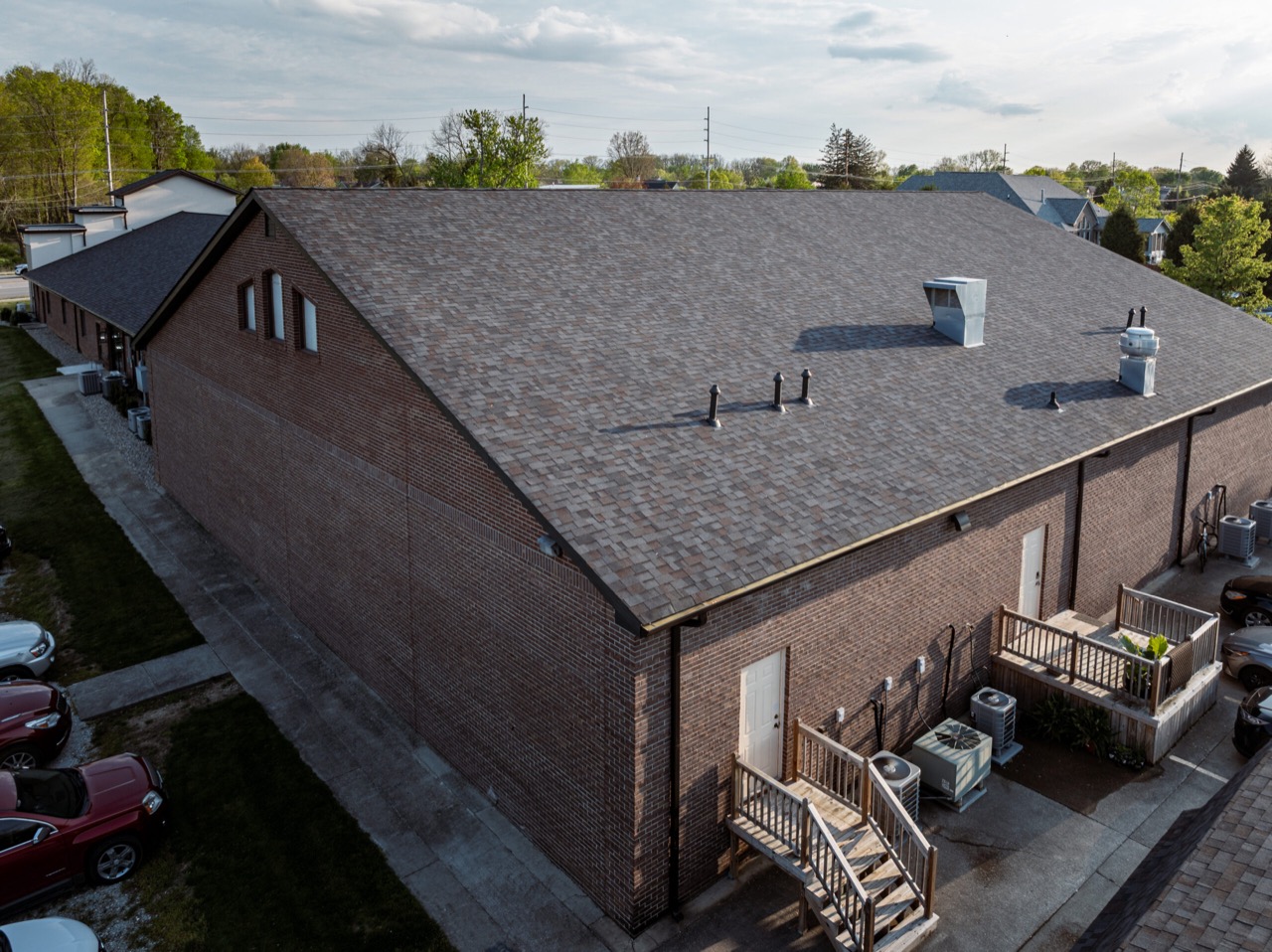 Aerial view across a completed polymer-modified asphalt shingle roof in Carmel, Indiana