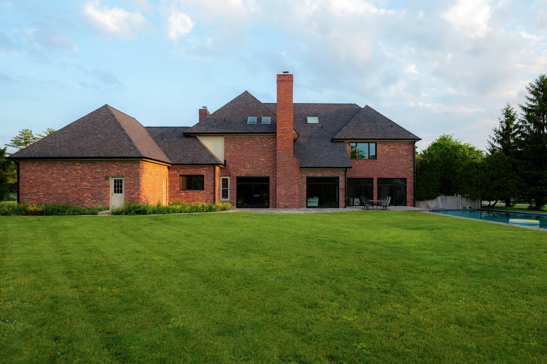 Rear elevation with roofing, siding, windows and patio doors in Carmel, Indiana