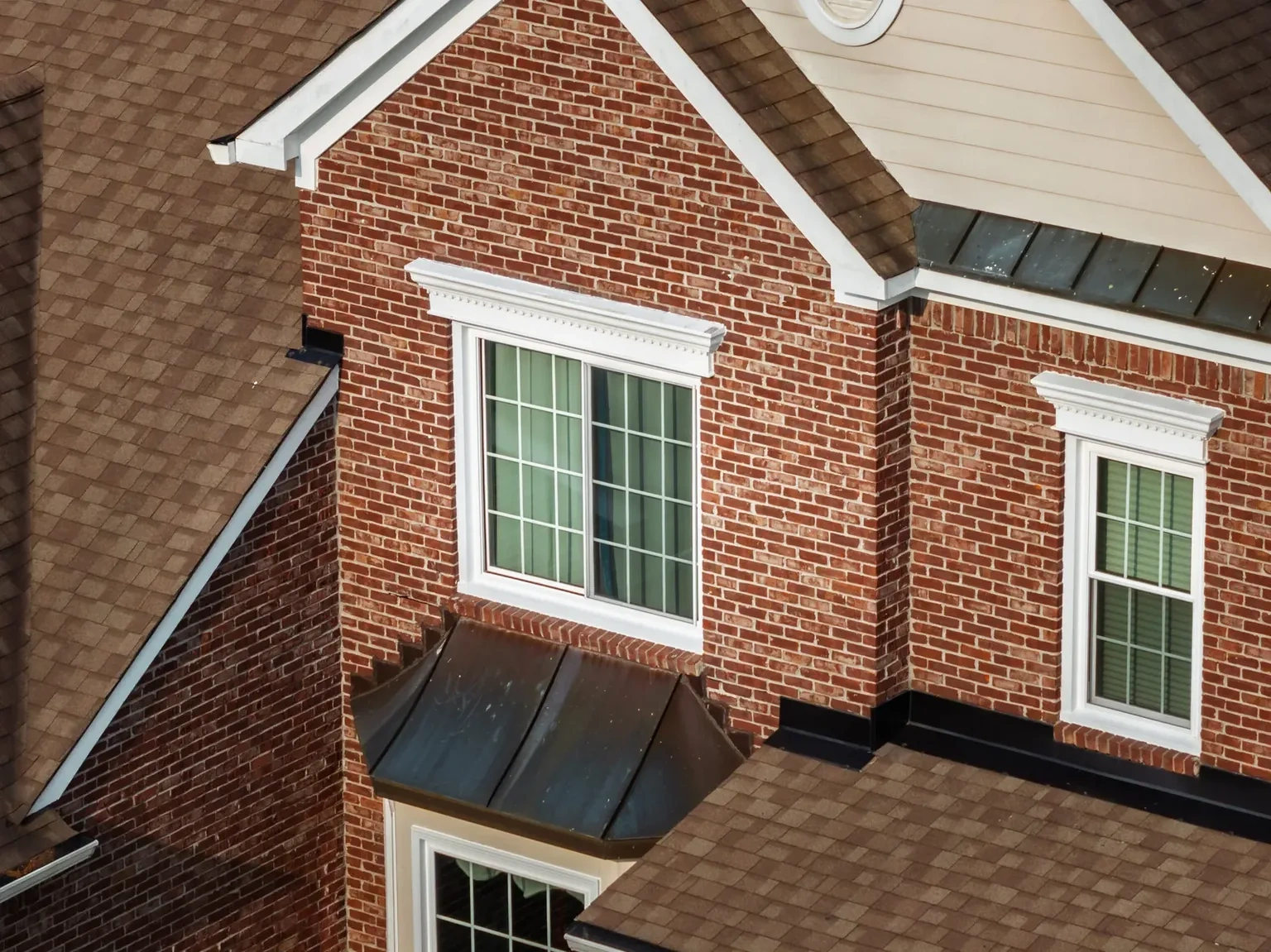 Projecting window assembly with a metal cap on a brick Greenwood, Indiana home