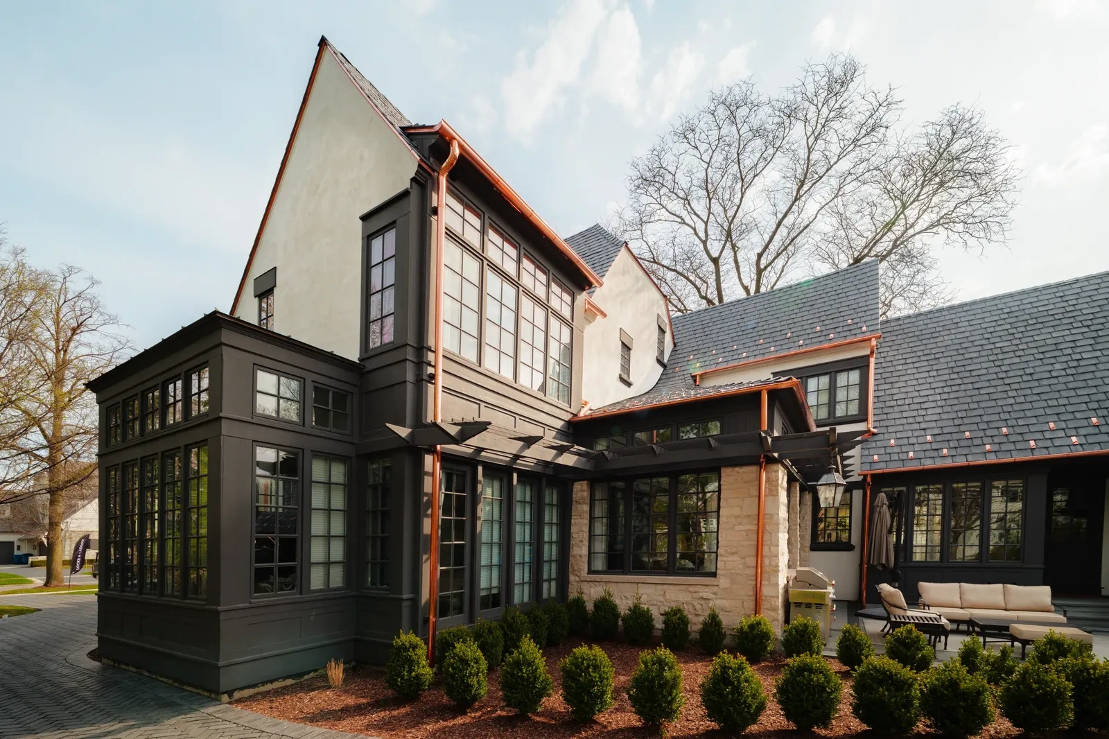 Copper downspouts following multiple rooflines and exterior wall transitions on the Hinsdale residence