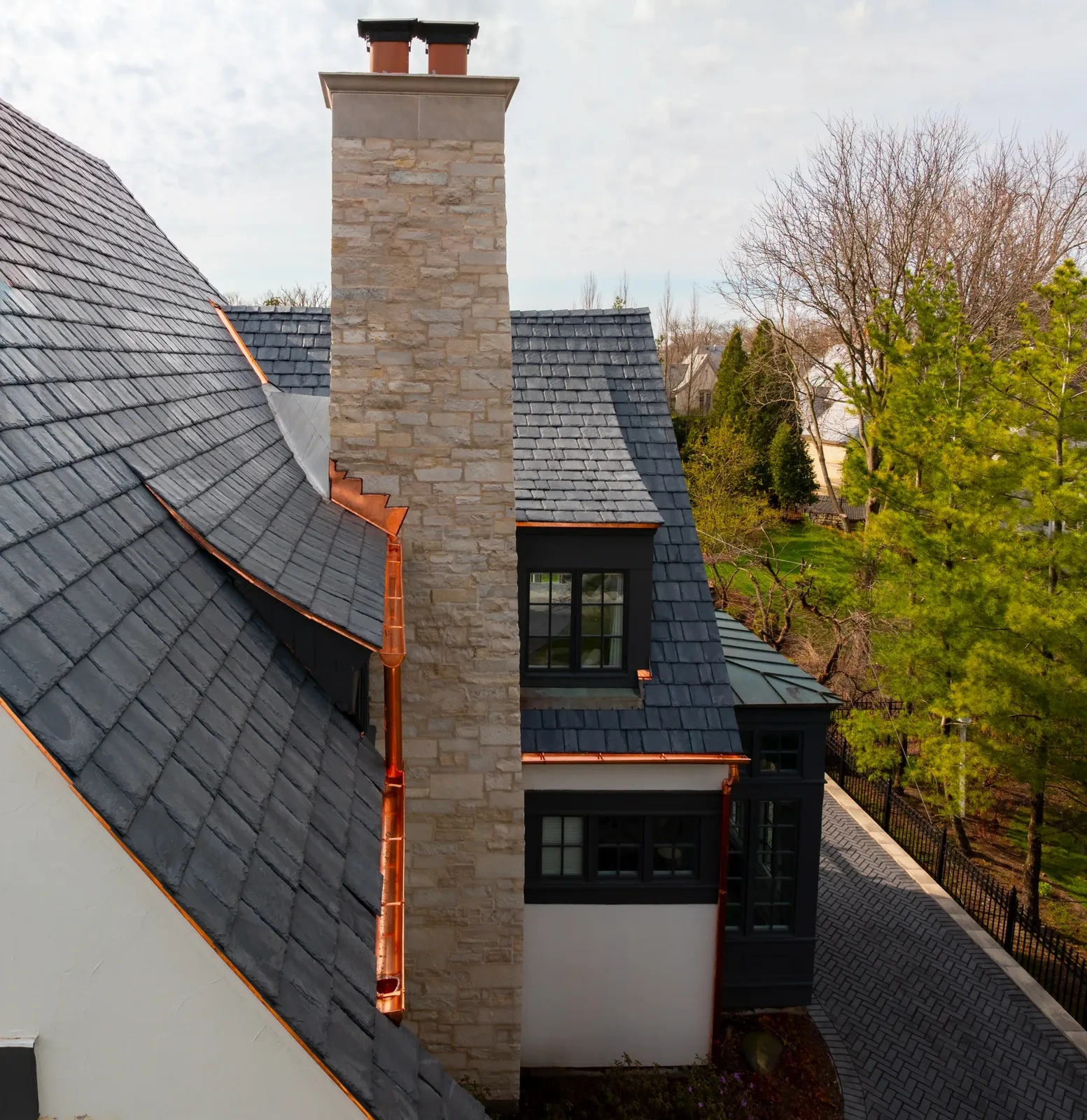 Close architectural view of copper flashing, gutters, and roof-edge detailing at the Hinsdale residence