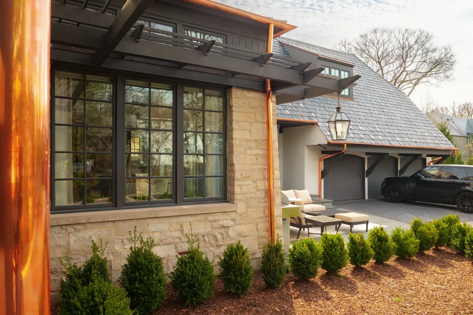 Copper gutter against a stone wall detail on the Hinsdale residence by Locke & Ladder