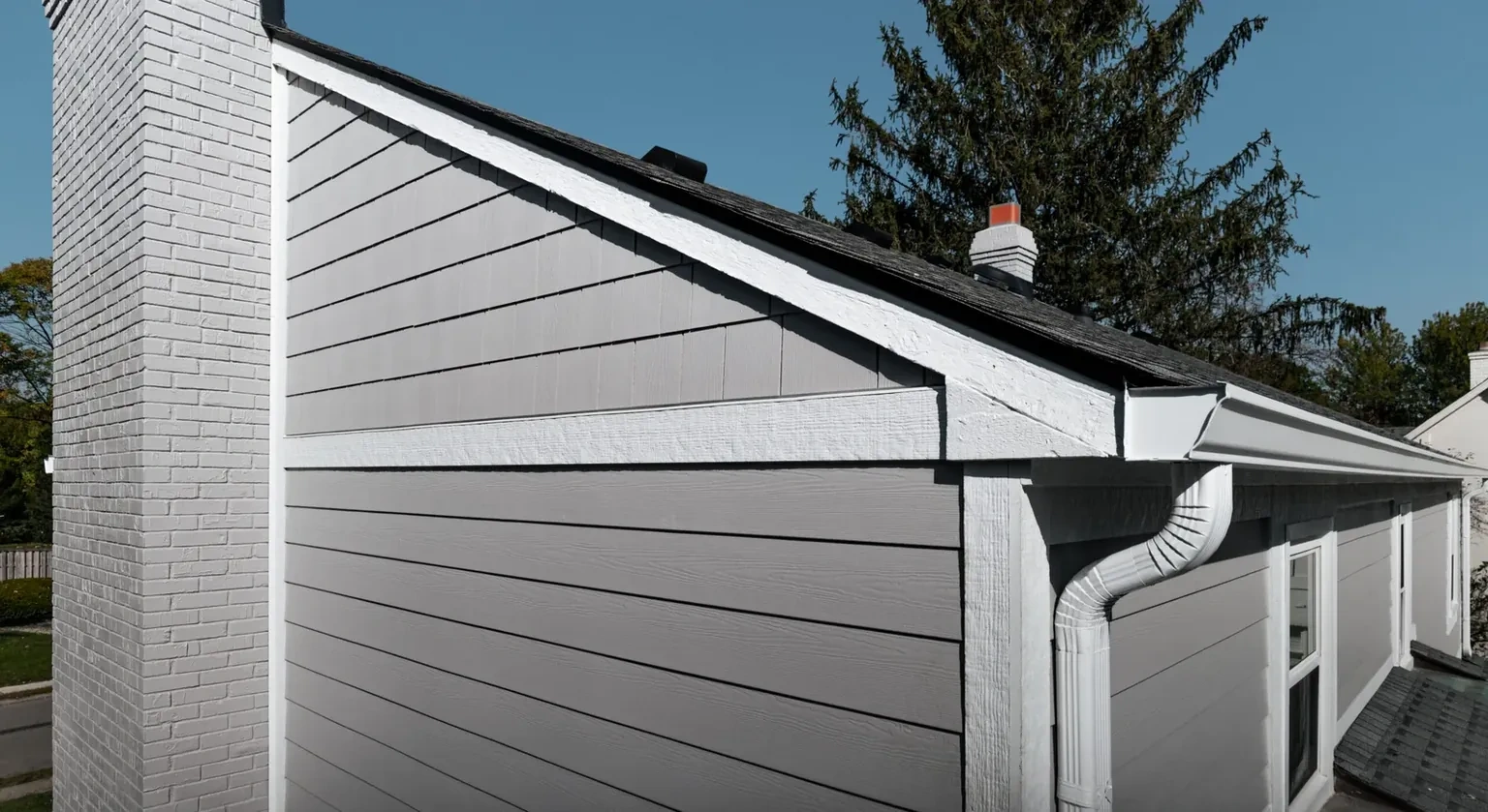 Finished horizontal vinyl siding with straight courses and wrapped exterior details
