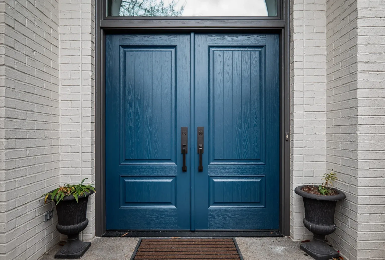 Blue double entry doors with a glazed transom on an Indianapolis home