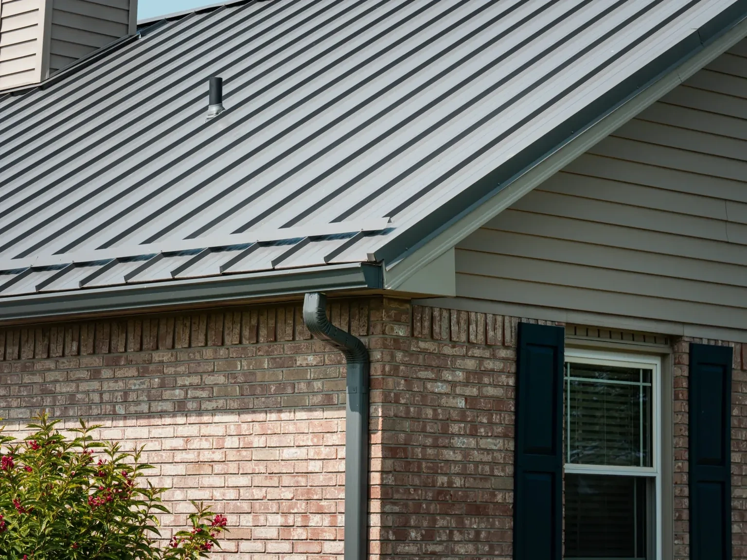 Close view of charcoal standing-seam metal panels and concealed raised seams