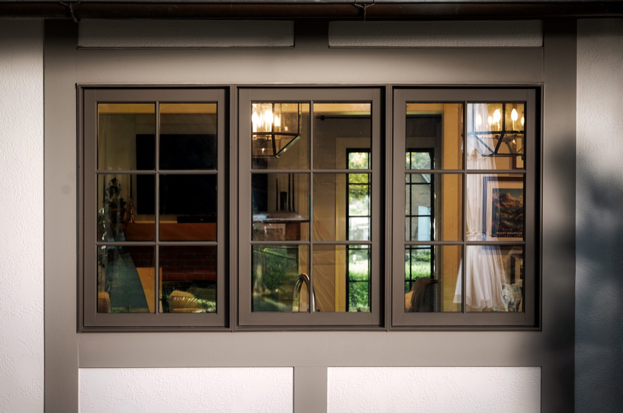 Three black-framed gridded windows with the glass clearly visible on a Wynnedale home in Indianapolis