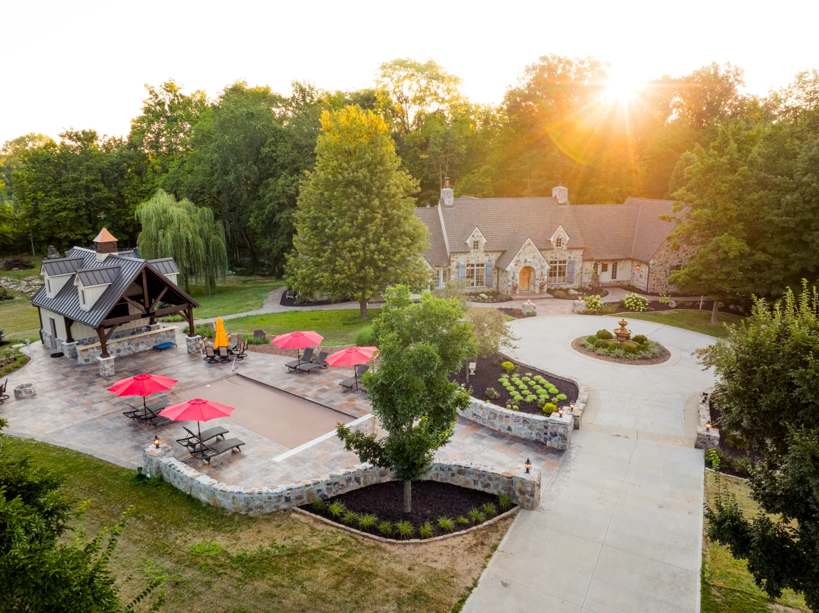 Aerial view of the Brava-roofed residence and standing-seam metal pool house