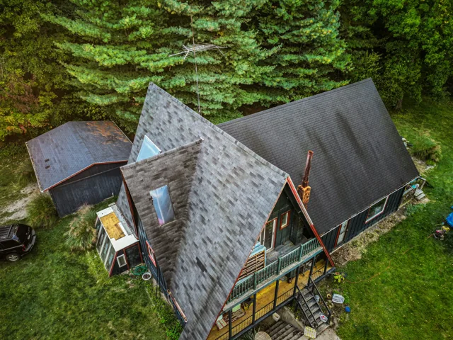 Roofing professional inspecting a roof to diagnose a repair