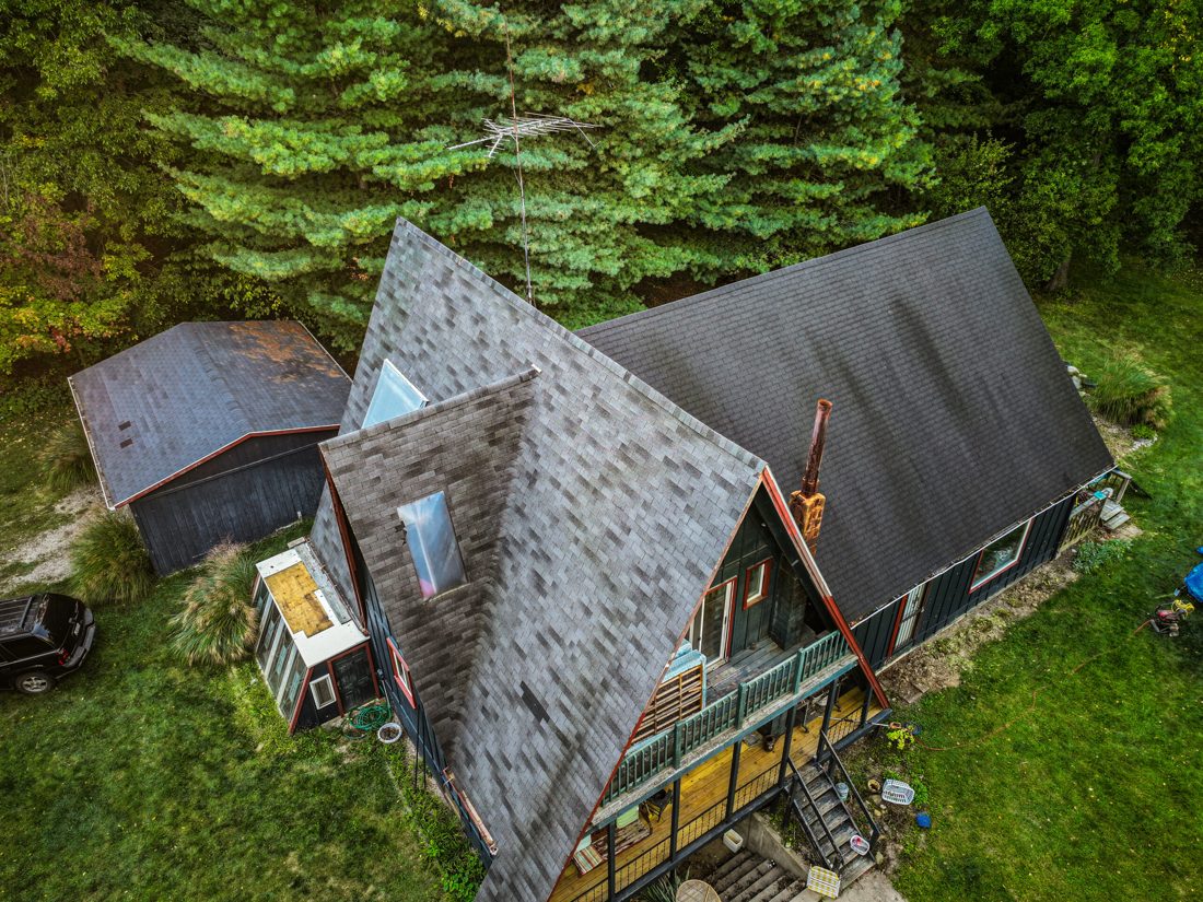 Aerial of the Walker home before its roof replacement, the old weathered shingles still in place