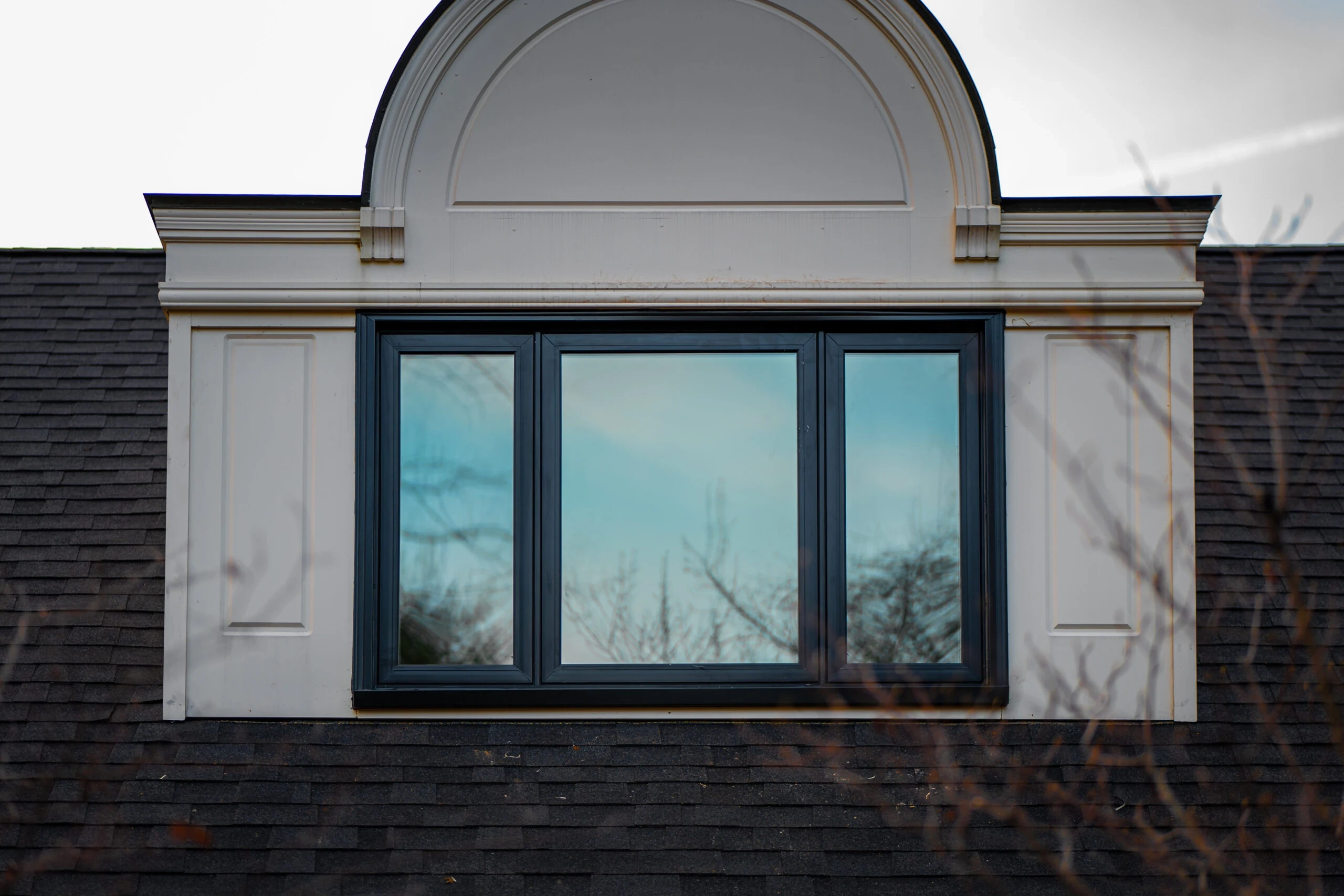 Large fixed center picture window with narrow flanking windows on a Spring Mill home