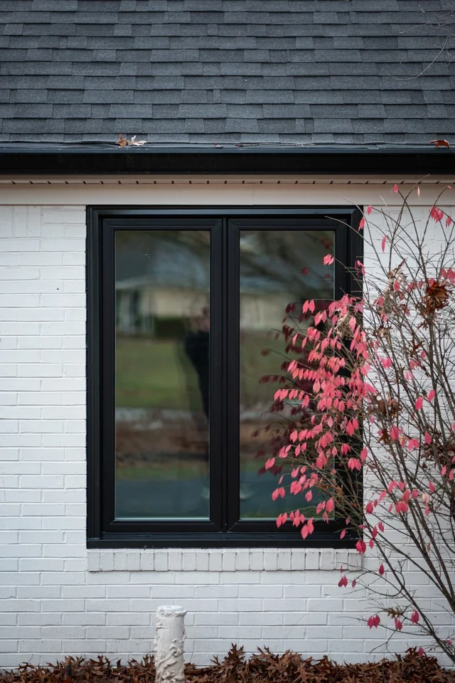 Black casement window pair on a white-brick Spring Mill, Indianapolis home